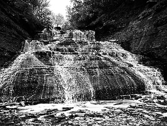 Black and White Waterfall Cascading Over Rocks