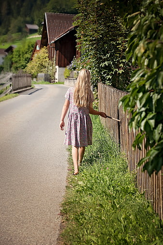 Little Girl Walking Away on Rural Road in Summer
