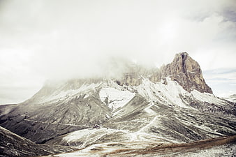 Majestic Snow-Capped Mountain Peak with Clouds and Ski Slopes