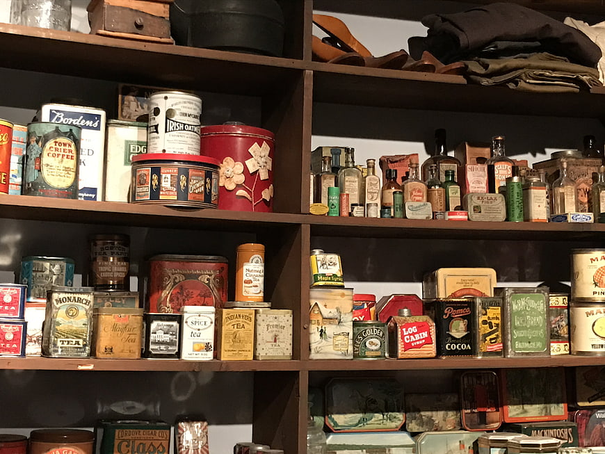 Vintage Antique Food Tins And Bottles On Wooden Store Shelves