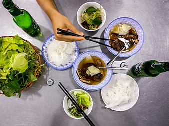 Top view of Vietnamese Bun Cha noodles with beer and herbs
