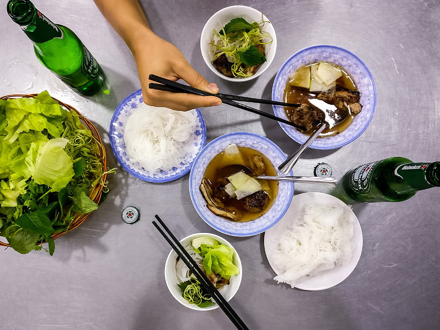 Top view of Vietnamese Bun Cha noodles with beer and herbs