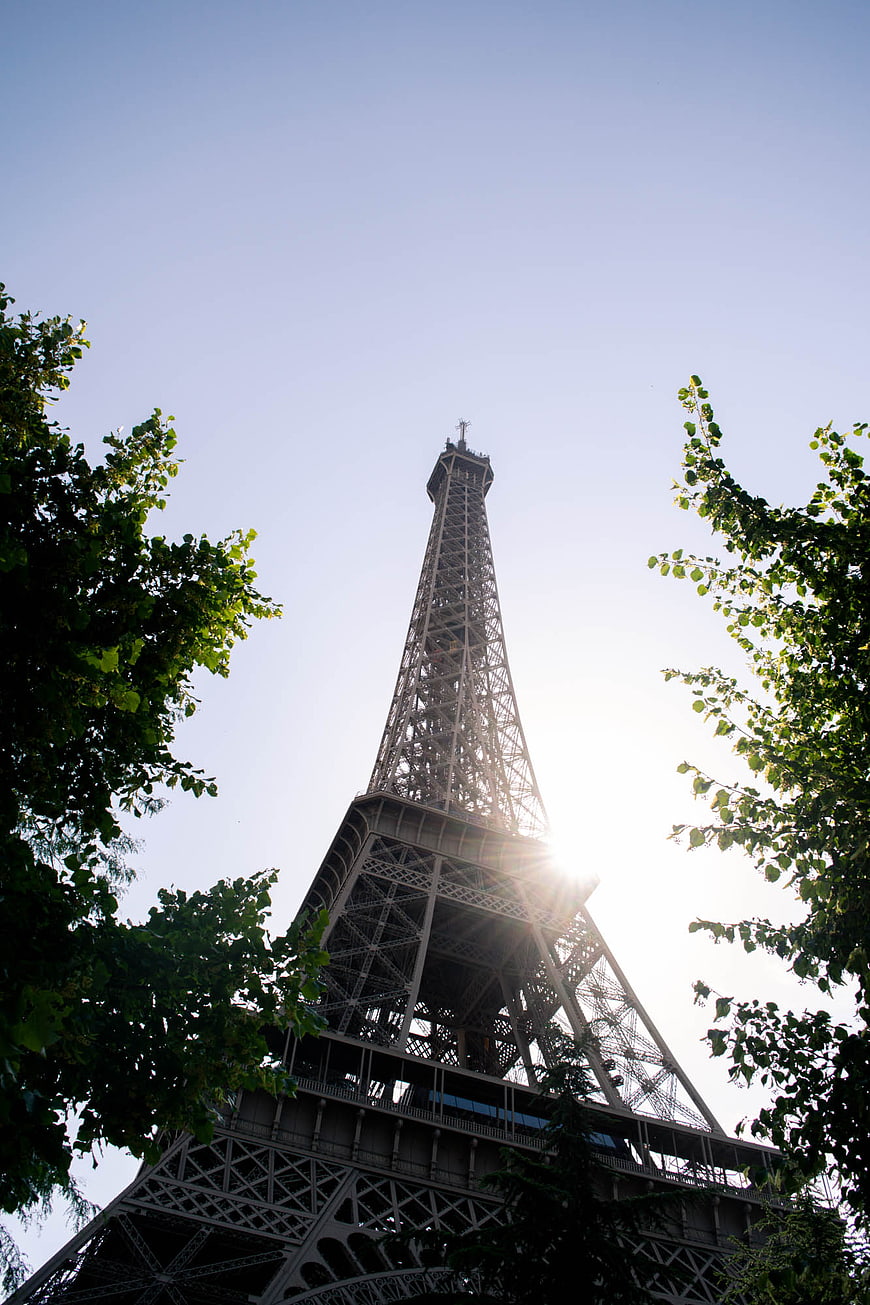 Eiffel Tower Sunburst Through Trees in Paris
