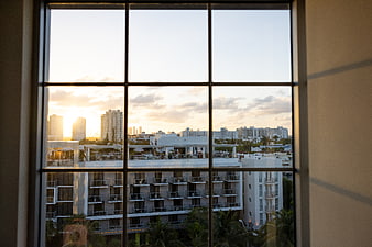 Sunset cityscape view through large window grid