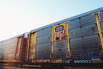 Rusty Union Pacific Freight Train Car on Tracks