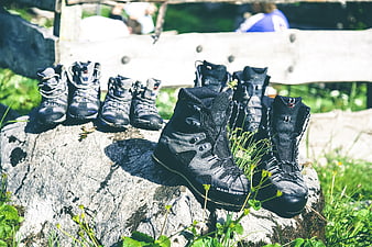 Hiking boots on a rock in a sunny meadow