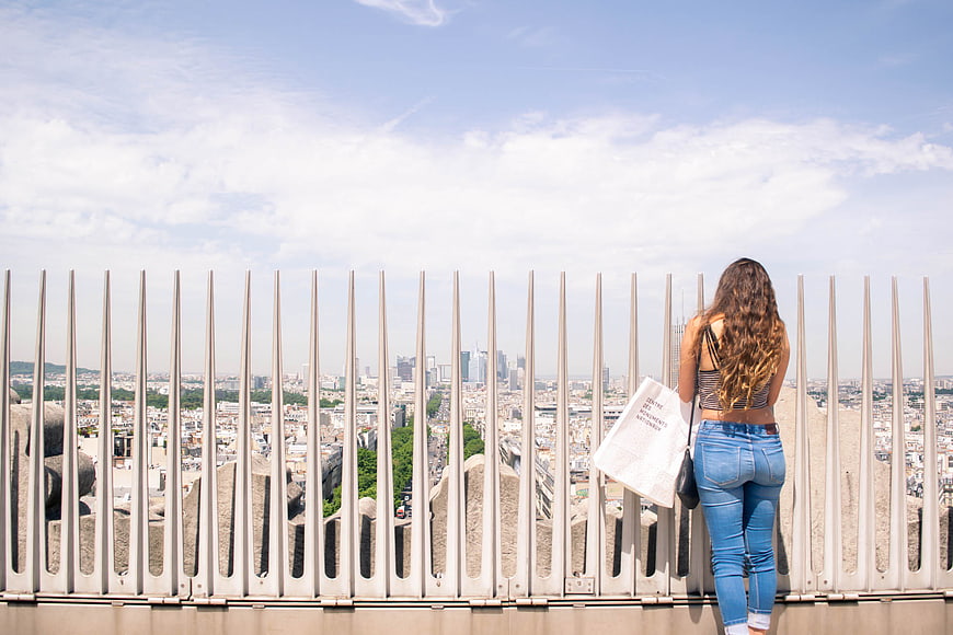 Woman with Shopping Bag Looking at Paris Cityscape
