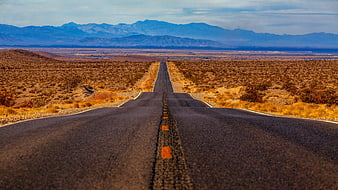 Long Desert Highway Stretching to Distant Blue Mountains