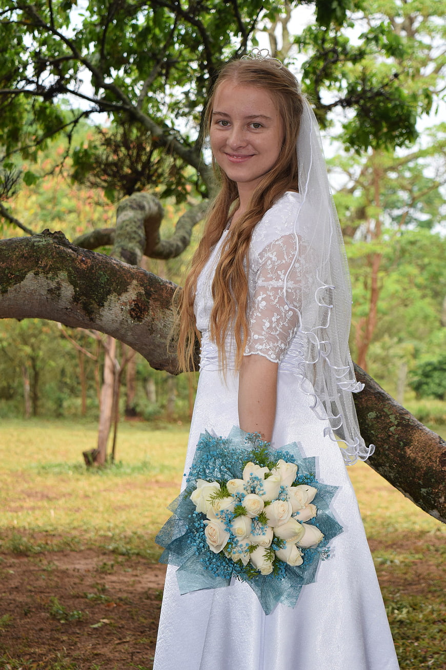 Young Bride in White Dress Holding Blue and White Bouquet