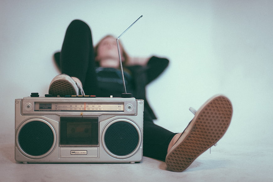 Vintage boombox with woman relaxing in background