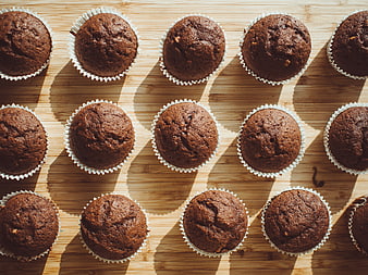 Top View of Fresh Chocolate Muffins on Wooden Board