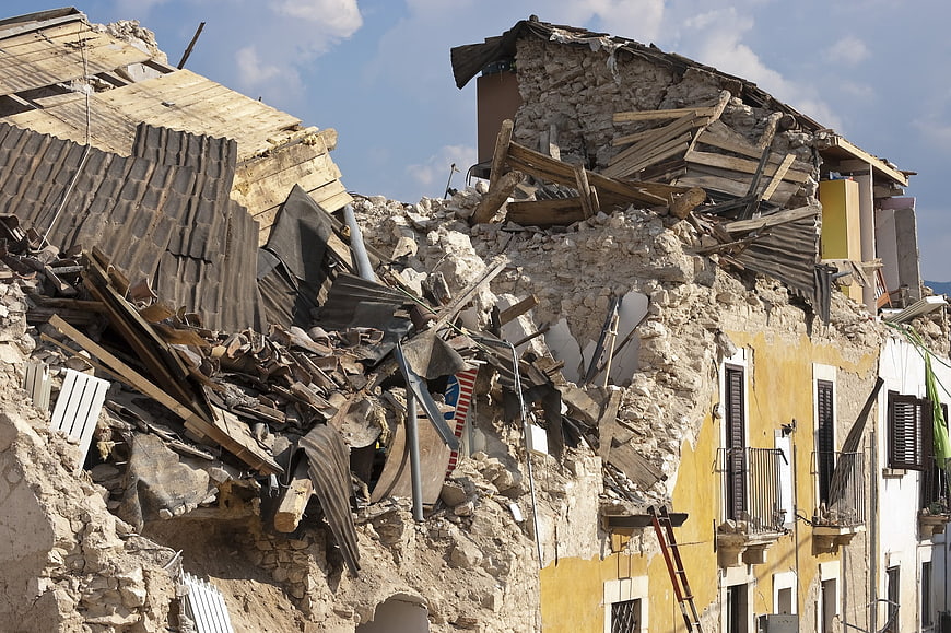 Collapsed stone building rubble after earthquake disaster
