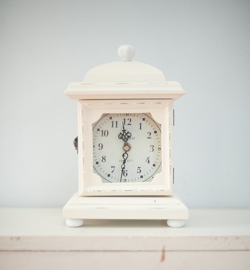 Vintage White Mantel Clock on Wooden Shelf