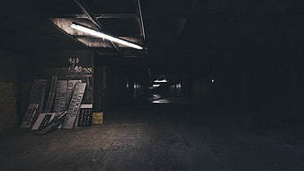 Dark abandoned underground tunnel with street signs