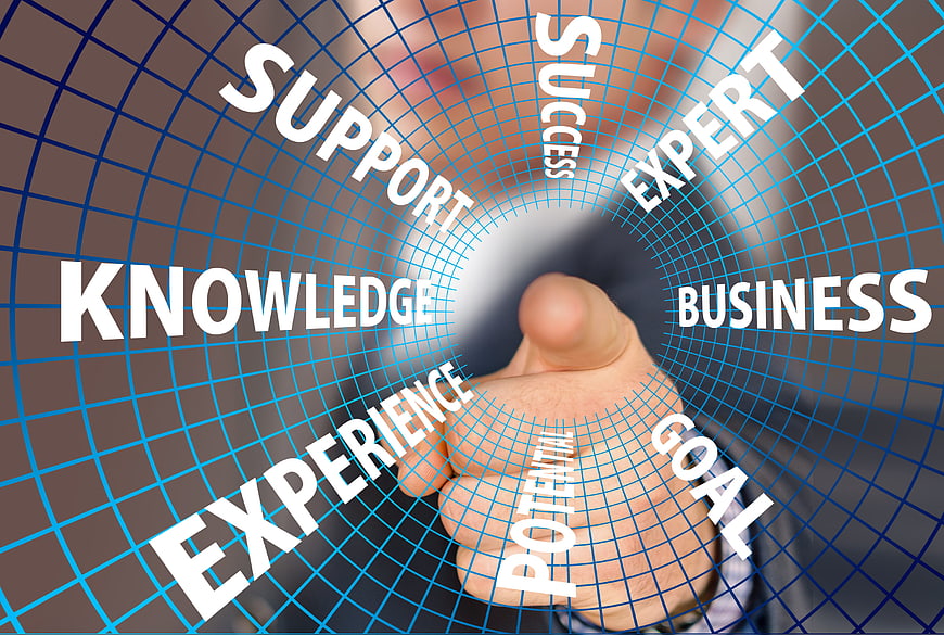 Businessman touching digital grid with success and knowledge text