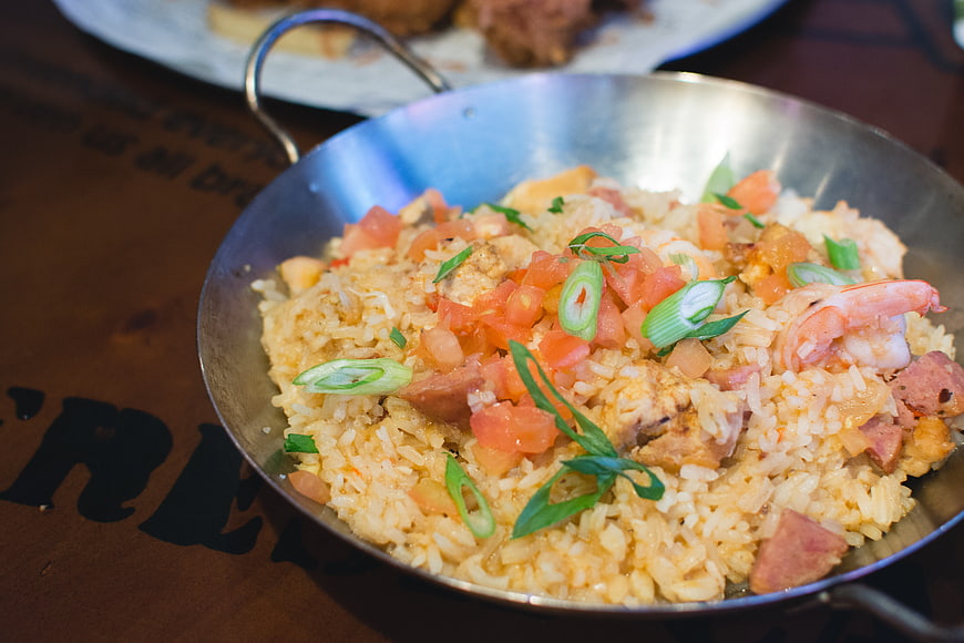 Seafood fried rice with shrimp and sausage in metal pan