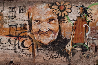 Street art mural of elderly woman face and cartoon figure