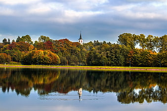 Serene Lake Reflection of Church and Autumn Trees