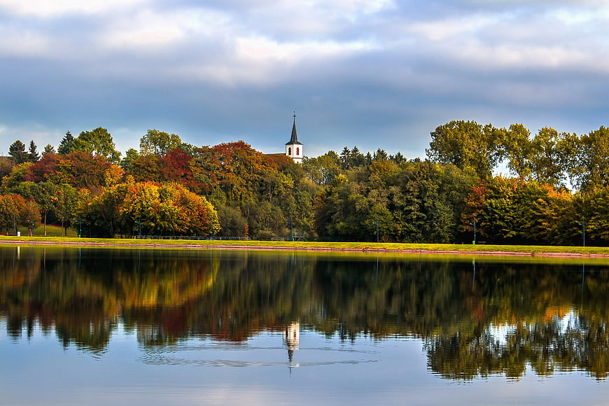 Serene Lake Reflection of Church and Autumn Trees