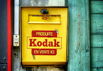 Vintage Yellow Kodak Film Drop Box on Wooden Wall