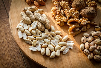 Assorted Nuts on Wooden Board with Peanuts, Walnuts, and Pistachios