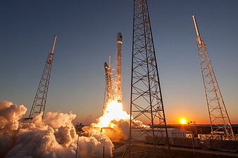 Rocket Launch at Sunset with Smoke and Launch Towers