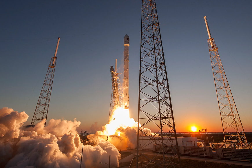 Rocket Launch at Sunset with Smoke and Launch Towers