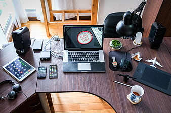 Modern Workspace with Laptop, Tablet, and Tech Gadgets
