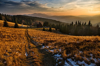 Golden Sunset Mountain Landscape with Cabin and Snow Patches