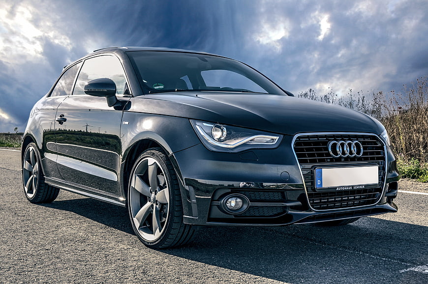 Black Audi A1 S-Line on Road with Dramatic Sky