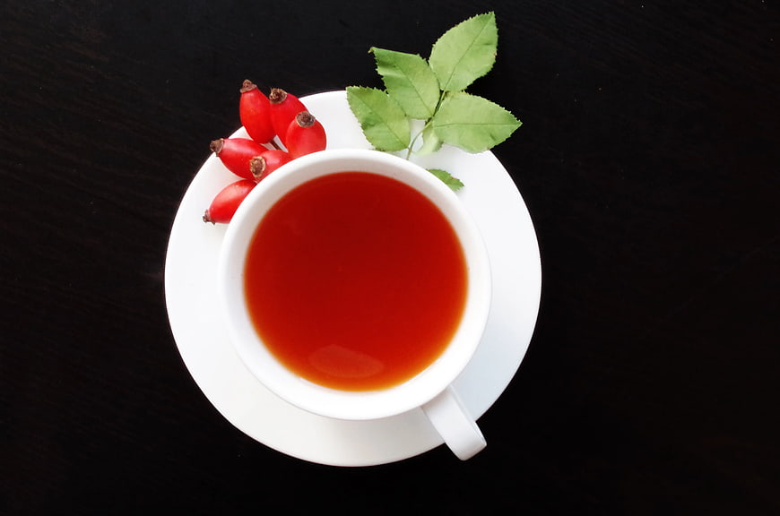Top View of Rosehip Tea in White Cup with Berries
