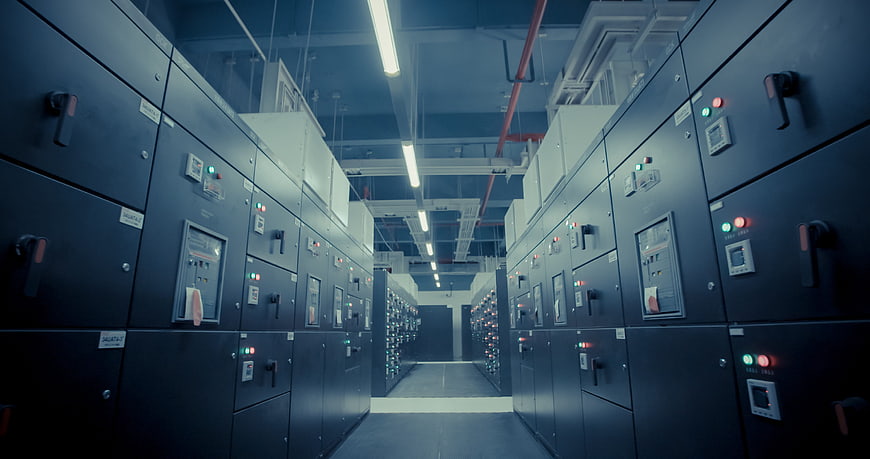 Industrial electrical switchgear room with rows of cabinets