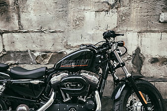Black Harley Davidson Forty-Eight Motorcycle Against Concrete Wall