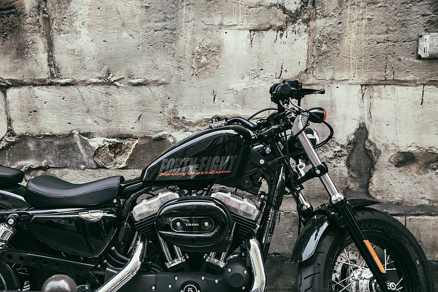 Black Harley Davidson Forty-Eight Motorcycle Against Concrete Wall