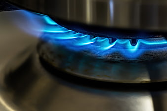 Close-up of blue gas flame on kitchen stove burner