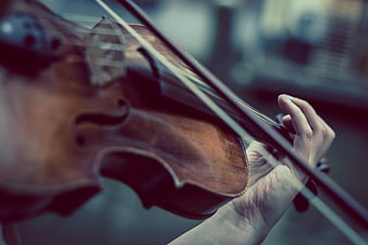 Close-up of hands playing a violin with cinematic lighting
