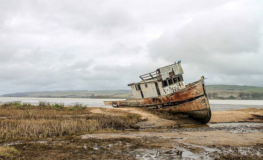Abandoned Rusty Fishing Boat on Sandy Beach