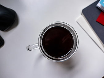 Top View of Black Coffee in Glass Mug on White Desk