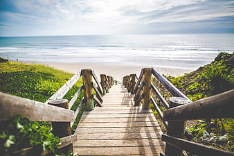 Wooden Boardwalk Leading to Sunny Beach and Ocean