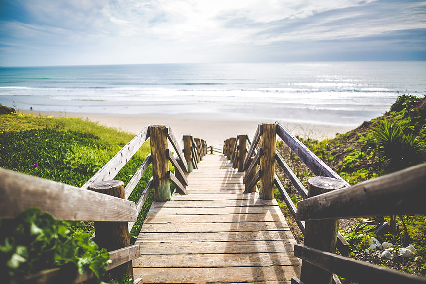 Wooden Boardwalk Leading to Sunny Beach and Ocean