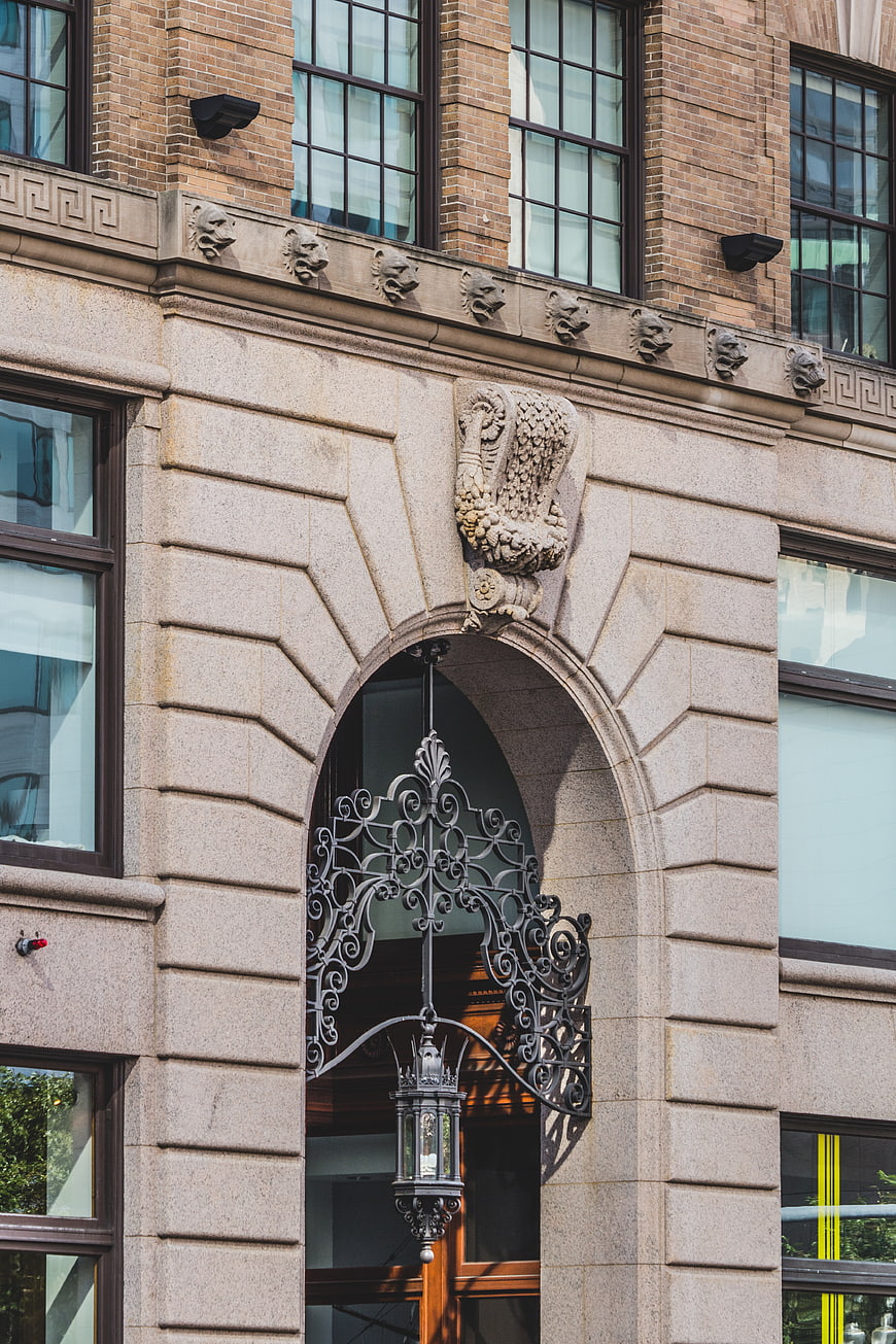 Ornate stone archway entrance with wrought iron lantern