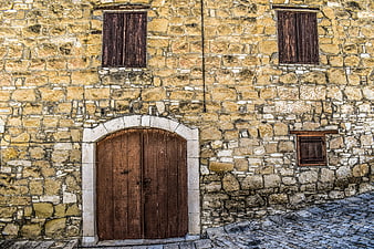 Old Stone House Facade with Wooden Door and Shutters
