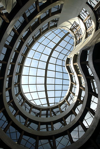 Low angle view of modern spiral glass atrium architecture