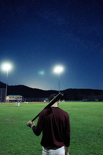 Baseball Player at Night Under Starry Sky