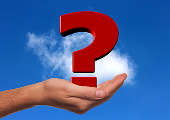 Hand holding red 3D question mark against blue sky