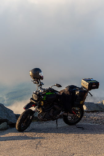 Adventure Motorcycle Parked on Mountain Peak at Sunset