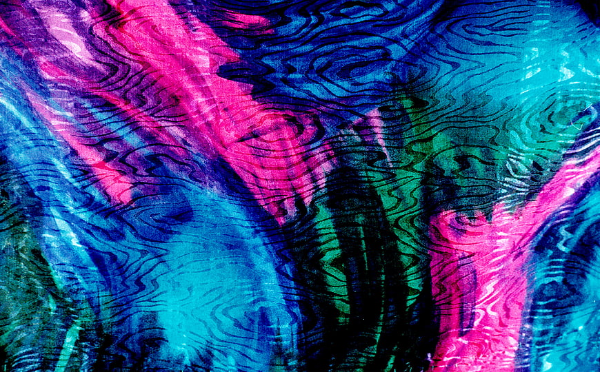 Abstract shiny multicolor fabric texture with blue and magenta swirls