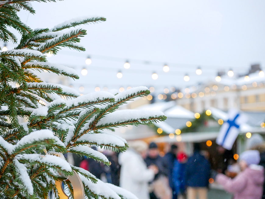Snowy Christmas Tree Branch with Bokeh Market Lights