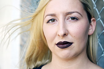 Close-up portrait of blonde woman with dark lipstick