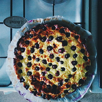 Top view of homemade blueberry cheesecake cooling on stove